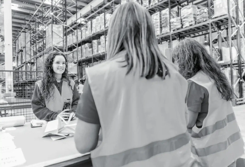 Warehouse workers talking with each other happily