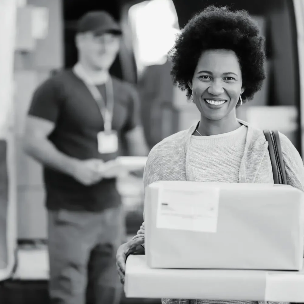 Smiling customer happily holding multiple delivered packages