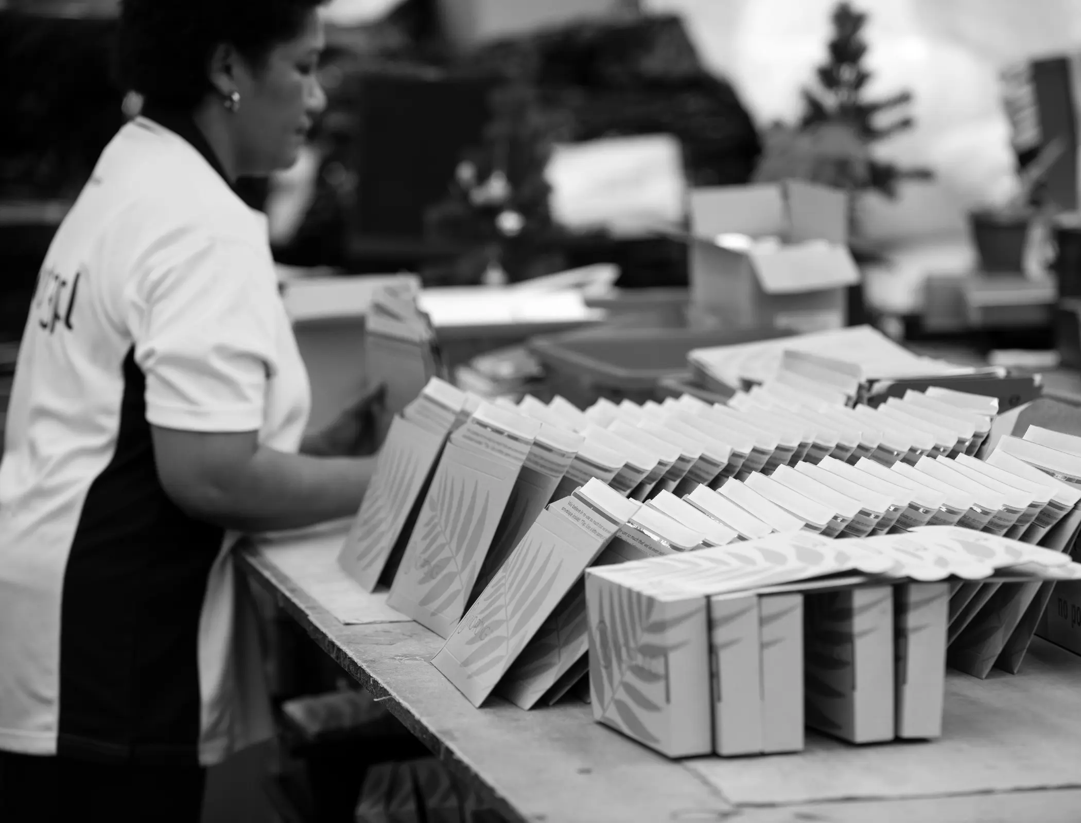 Female warehouse staff carefully preparing packages and bundling products
