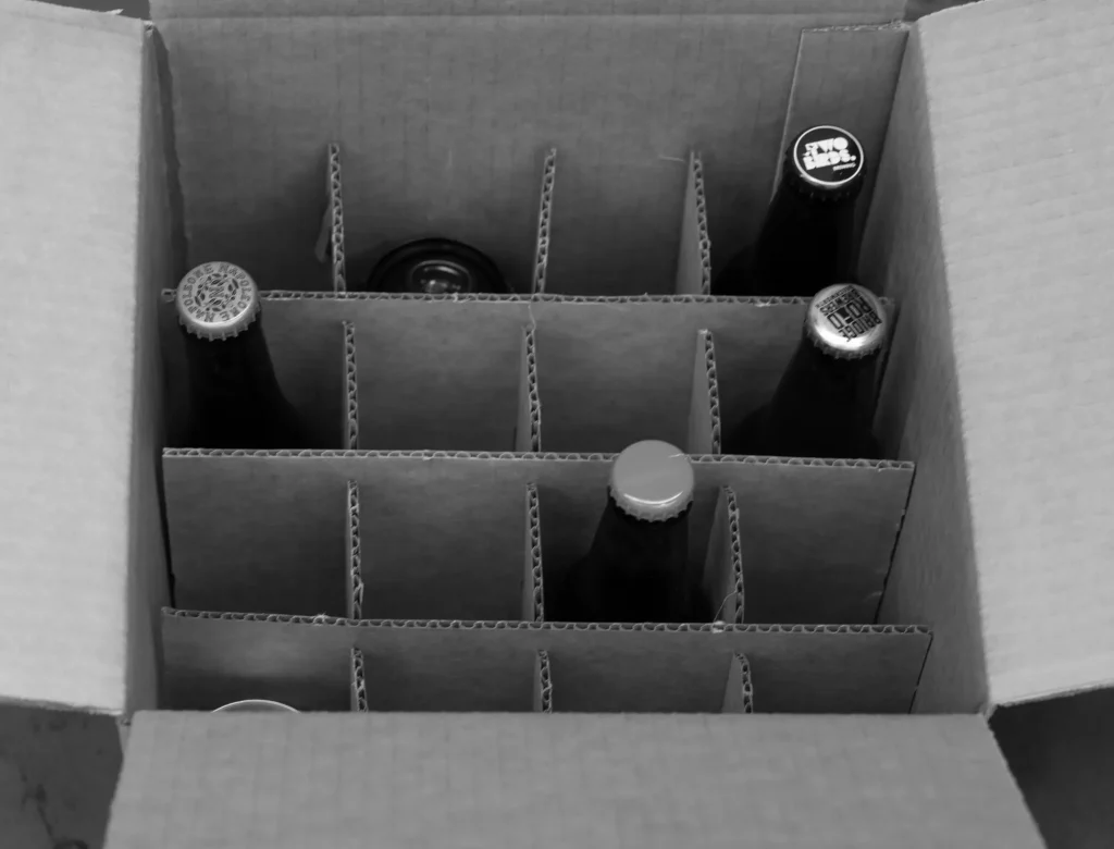 Warehouse specialist preparing bottle containers with precision hand assembly