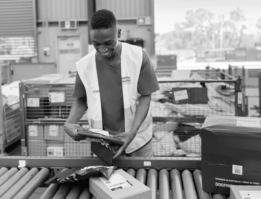 Skilled logistics specialist managing inventory in warehouse aisle